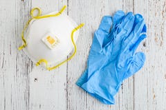 BELLEVUE, WA/USA – APRIL 30, 2020: PPE on a rustic white background, 3M N95 mask and blue nitrile gloves